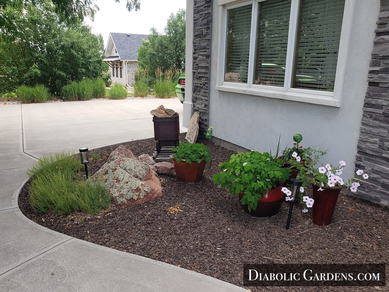 DGF Linda - cute landscaping west of walk path in front yard with mine cart